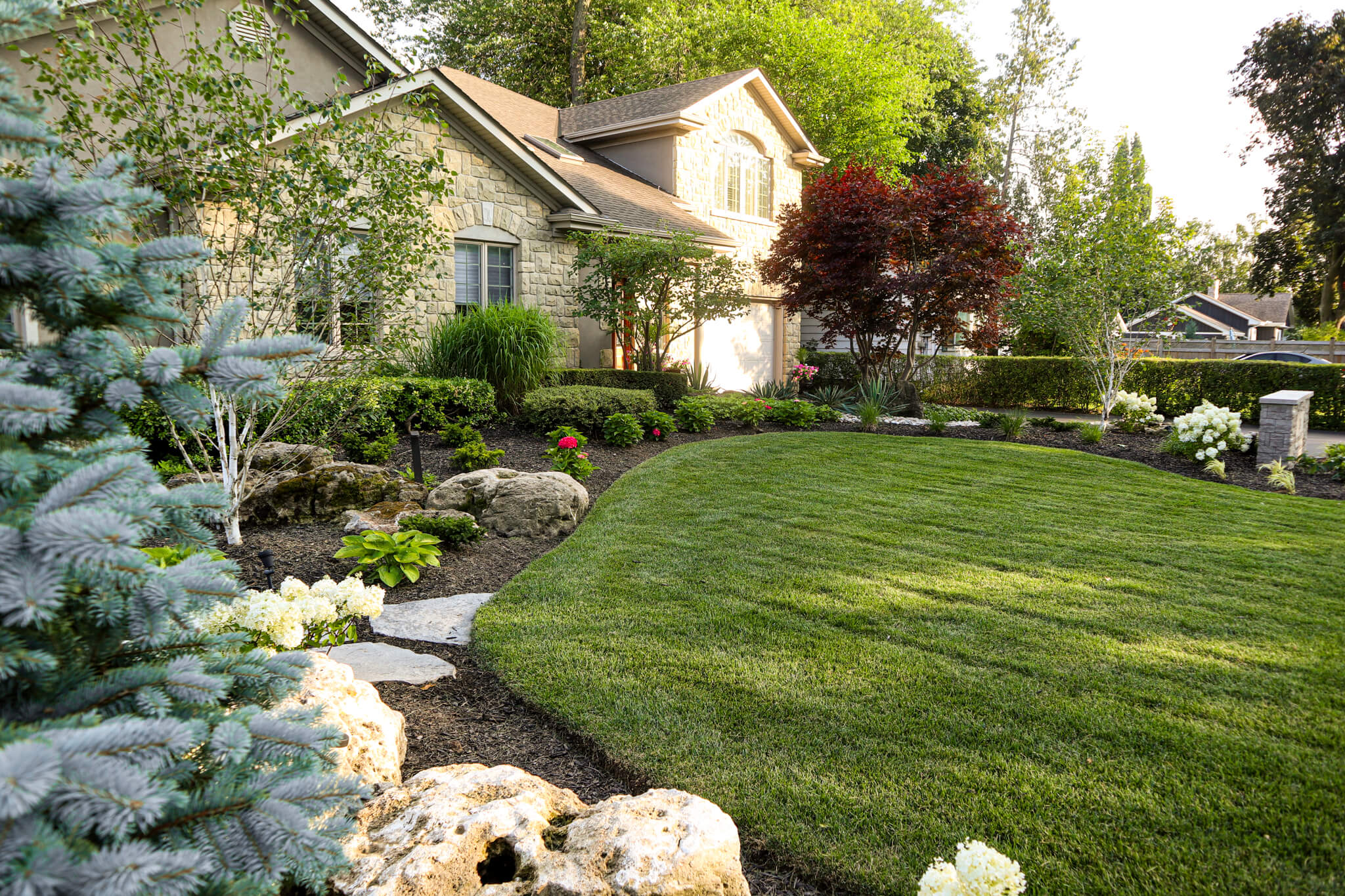 Residential landscaping project in Hamilton – Lush Front Yard Garden Bed