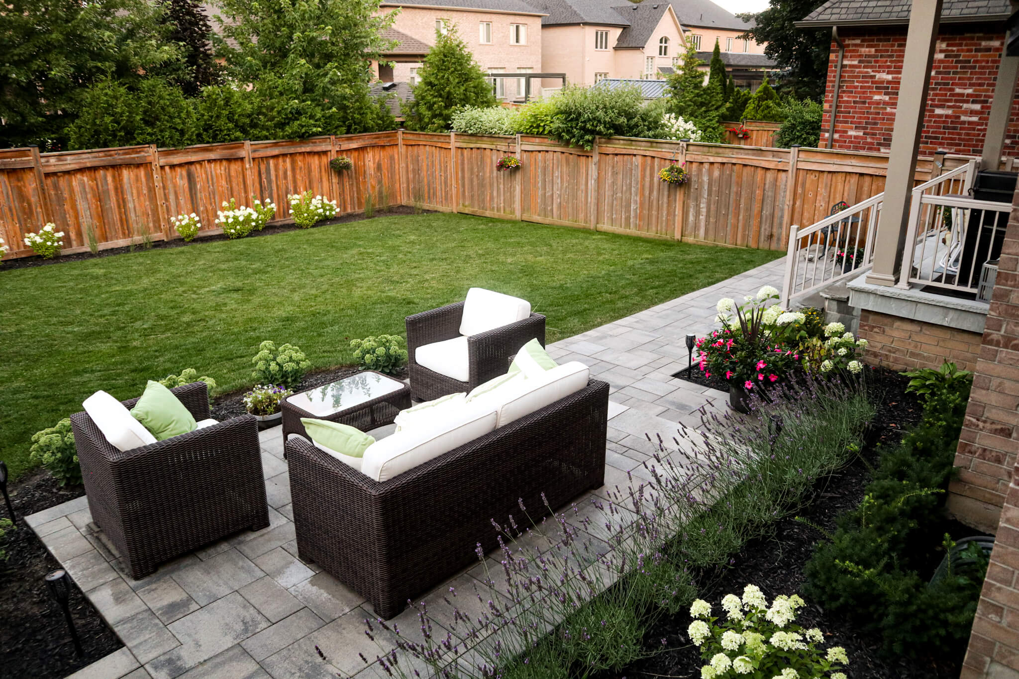 Residential landscaping project in Hamilton – small patio space with seating and large grass yard