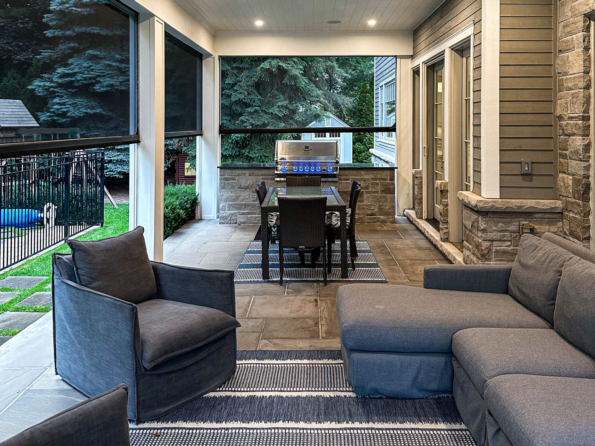 Residential landscaping project in Hamilton – Sheltered outdoor seating with stone veneer BBQ