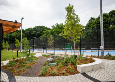 Garden with a gravel path that has amour stone seating and vibrant flowers