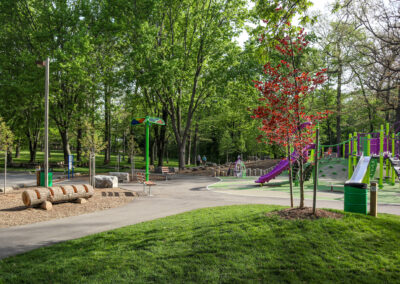 Seating area surrounded by tall green trees and grass at Mohawk Park in Brantford