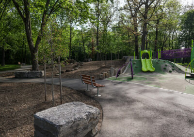 Armour Stone seating at Mohawk Park in Brantford surrounded my trees near a playground