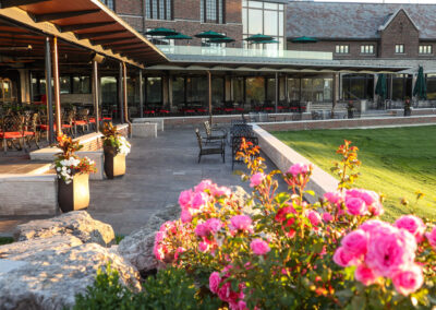 HGCC patio with tall flower pots with vibrant flowers