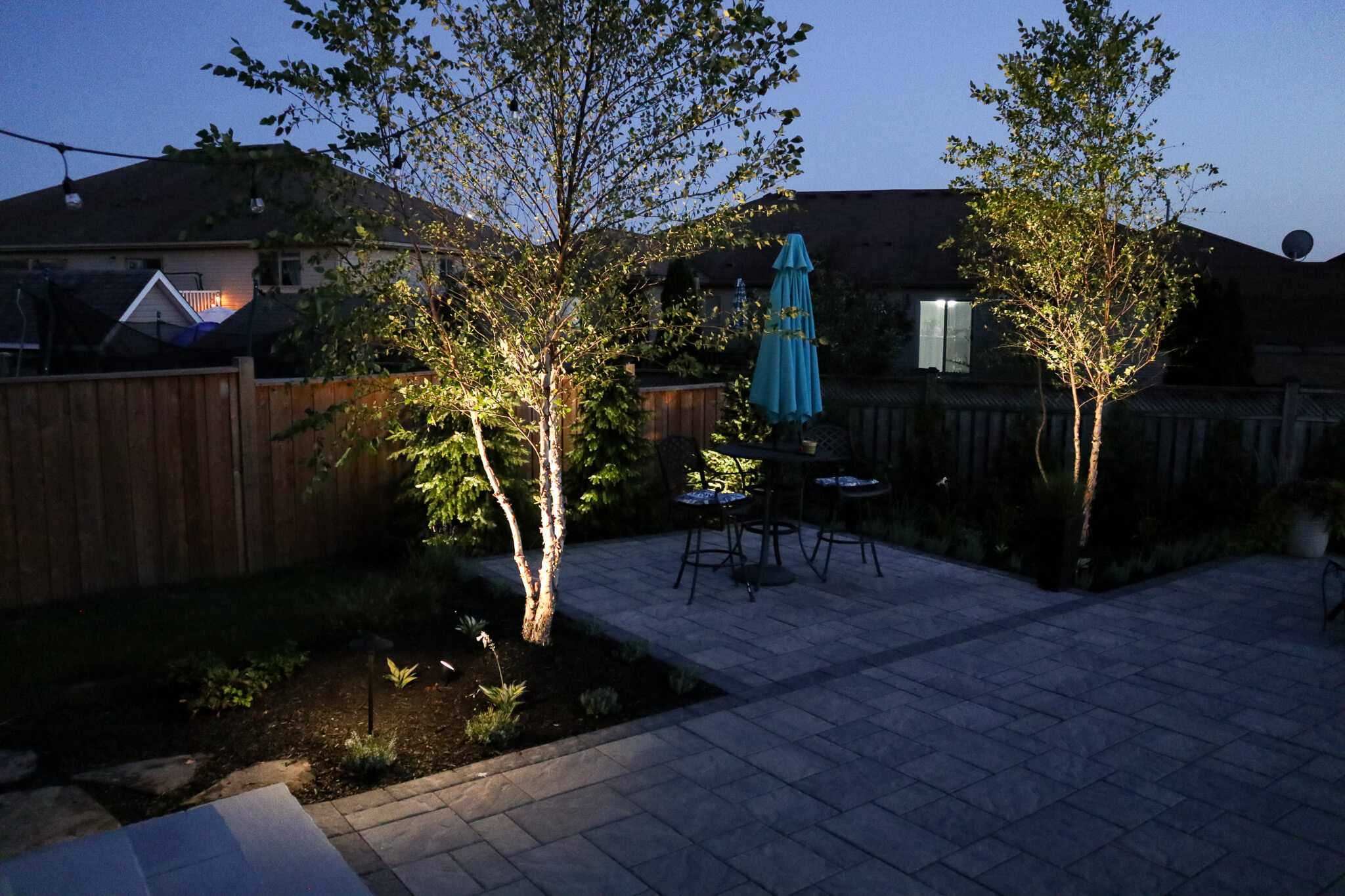 Ambient tree lighting enhancing a residential patio at night