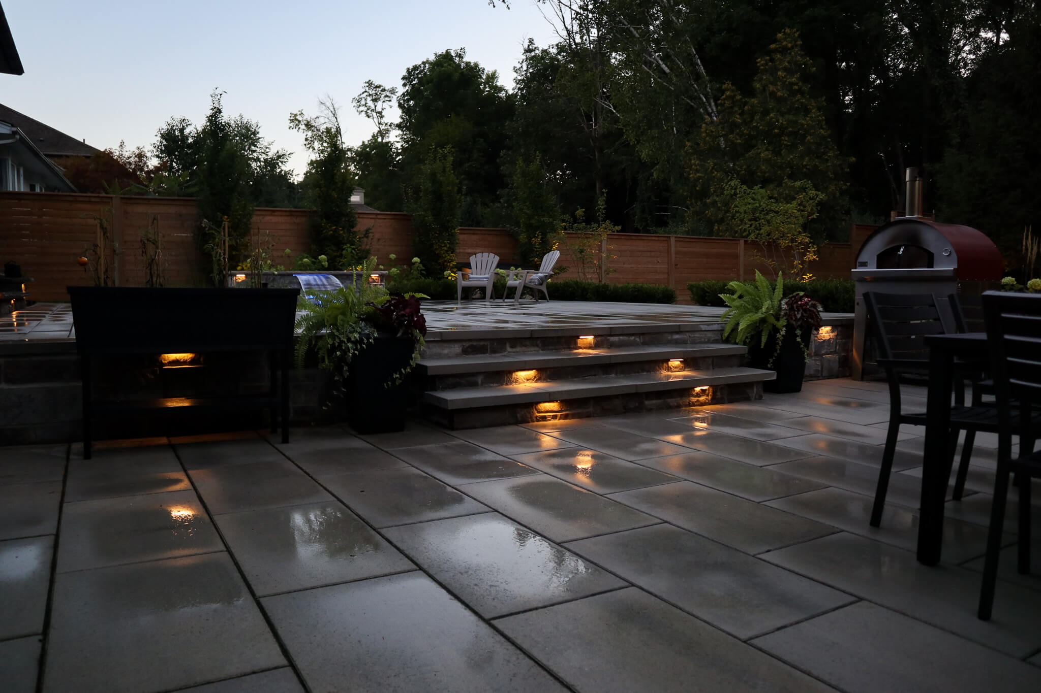 Built-in step lighting illuminating a residential patio at night
